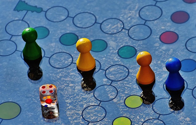 Family playing a board game around a table at home