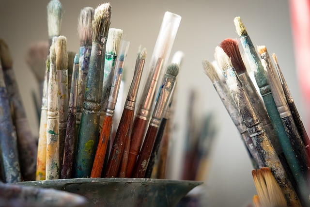 Person painting a vibrant abstract artwork on a canvas at home (fun things to do at home)
